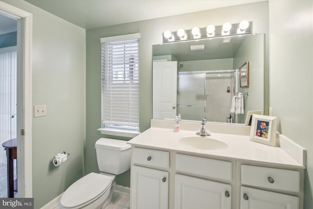 bathroom featuring toilet, vanity, and walk in shower