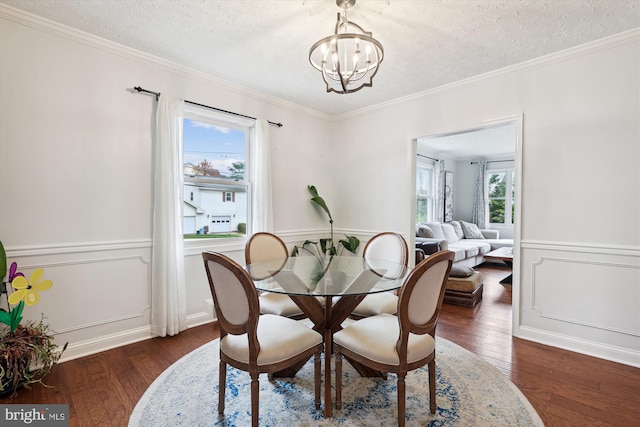 dining room with plenty of natural light, dark hardwood / wood-style floors, a chandelier, and a textured ceiling