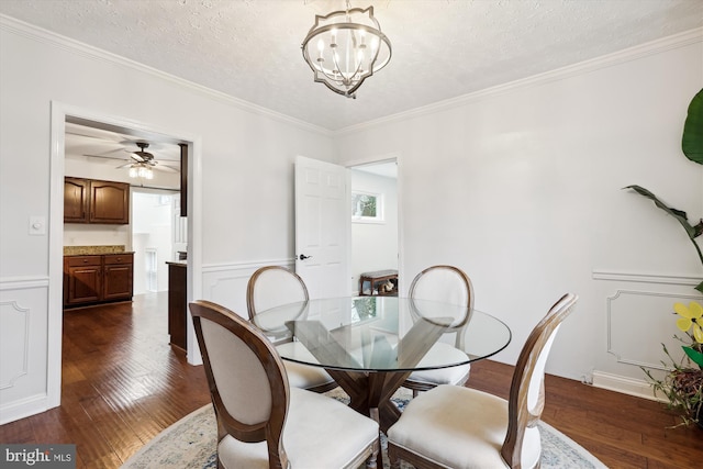 dining room featuring a chandelier, ornamental molding, dark hardwood / wood-style floors, and a textured ceiling