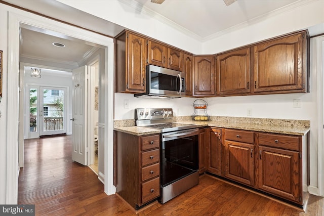 kitchen with stainless steel appliances, ornamental molding, light stone countertops, and dark hardwood / wood-style floors