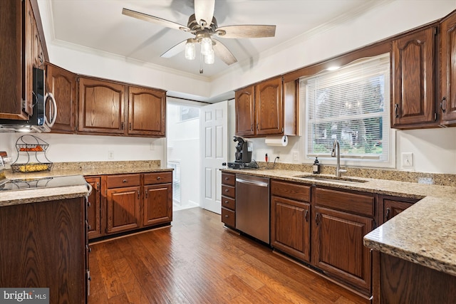 kitchen featuring sink, dark wood-type flooring, ornamental molding, and stainless steel appliances