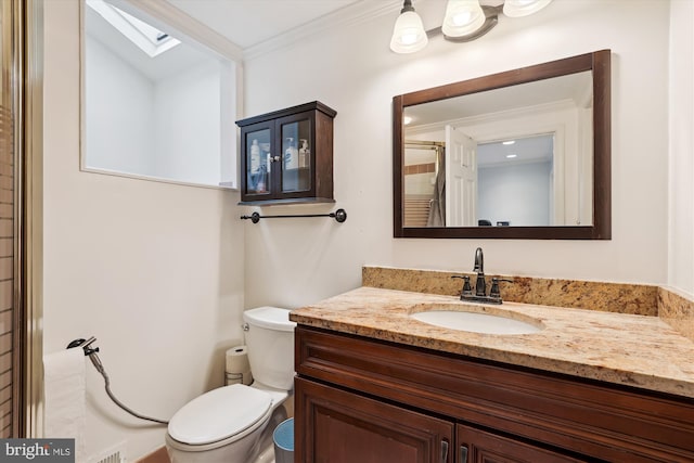 bathroom with walk in shower, toilet, crown molding, a skylight, and vanity