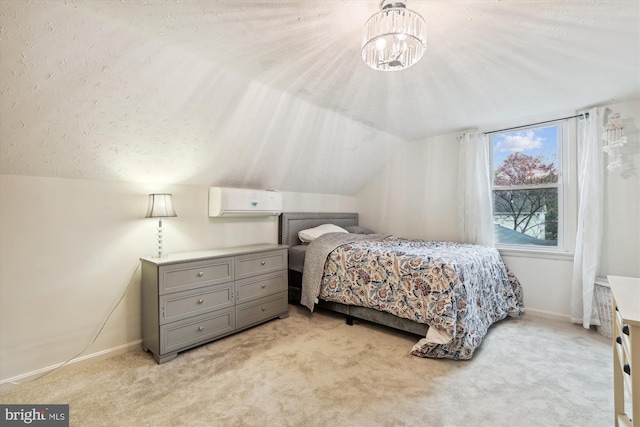 carpeted bedroom with a wall mounted AC and vaulted ceiling