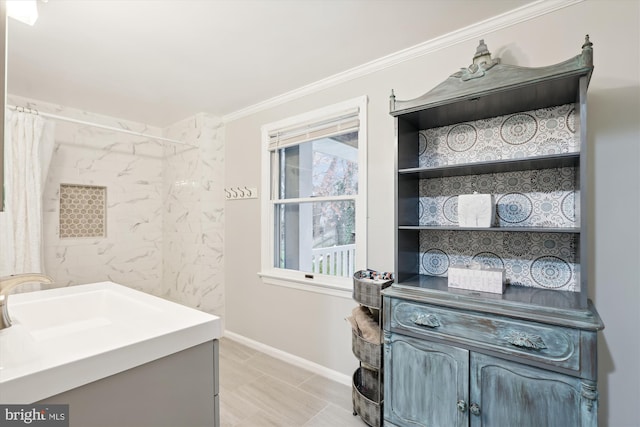 bathroom featuring crown molding and vanity