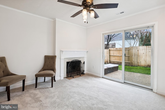 living area featuring ornamental molding, light colored carpet, and ceiling fan