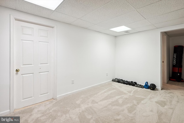 exercise room with carpet and a paneled ceiling