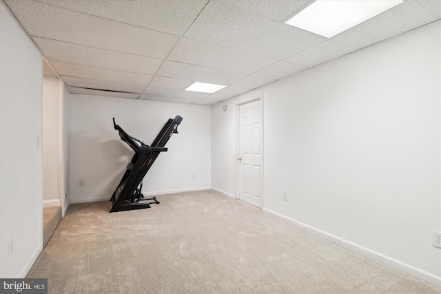 exercise area with light carpet and a drop ceiling