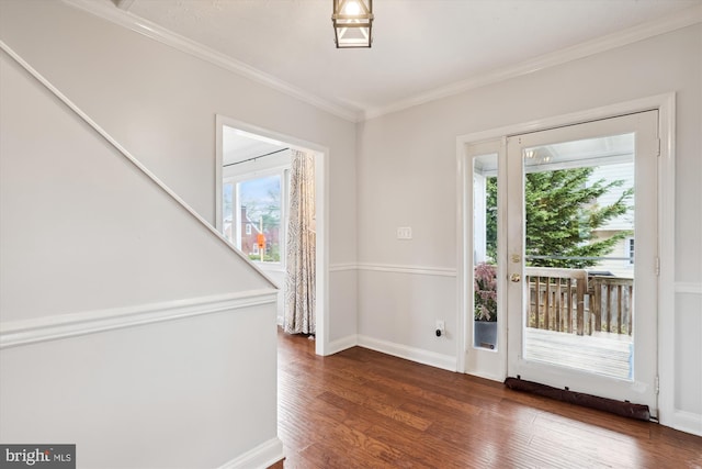 doorway to outside with dark wood-type flooring, ornamental molding, and a healthy amount of sunlight