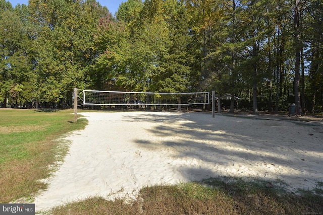 surrounding community featuring a yard and volleyball court