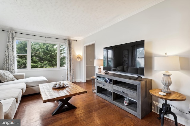 living room with ornamental molding, dark hardwood / wood-style floors, and a textured ceiling