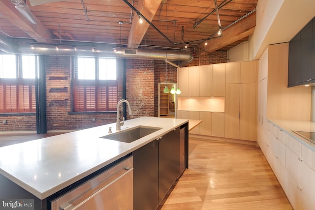 kitchen with a kitchen island with sink, wood ceiling, and brick wall