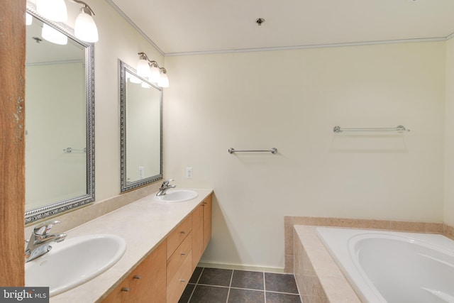 bathroom with tiled tub, ornamental molding, tile patterned floors, and vanity