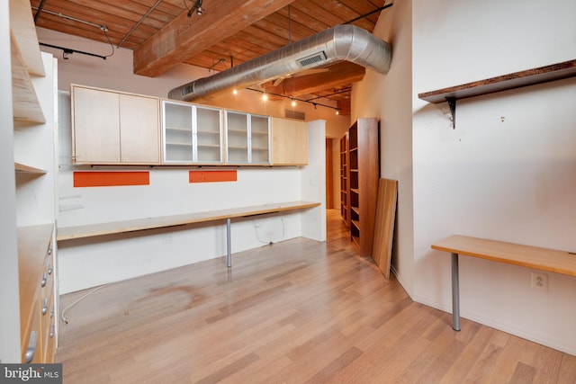 basement with wood ceiling, light hardwood / wood-style flooring, and track lighting