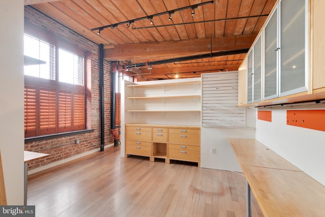 interior space featuring beam ceiling and light hardwood / wood-style flooring