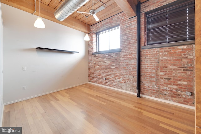 spare room featuring wood ceiling, brick wall, beam ceiling, and hardwood / wood-style floors