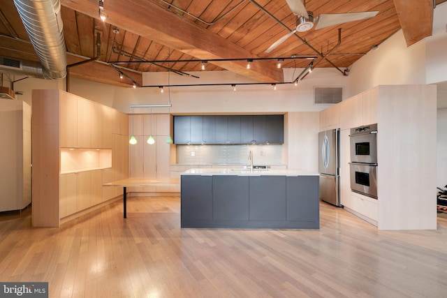 kitchen featuring sink, stainless steel appliances, wooden ceiling, and a high ceiling