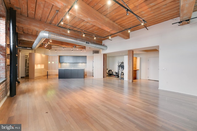 unfurnished living room featuring beam ceiling, wood ceiling, and hardwood / wood-style flooring