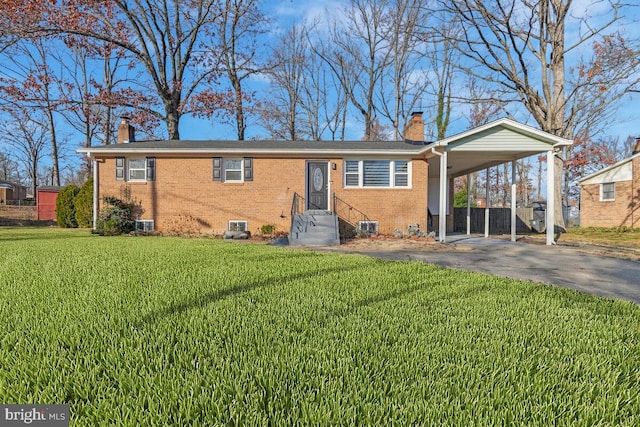 view of front of house featuring a front lawn, a carport, and central air condition unit