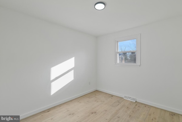 spare room featuring light hardwood / wood-style flooring