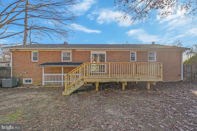 rear view of house with central AC unit and a deck