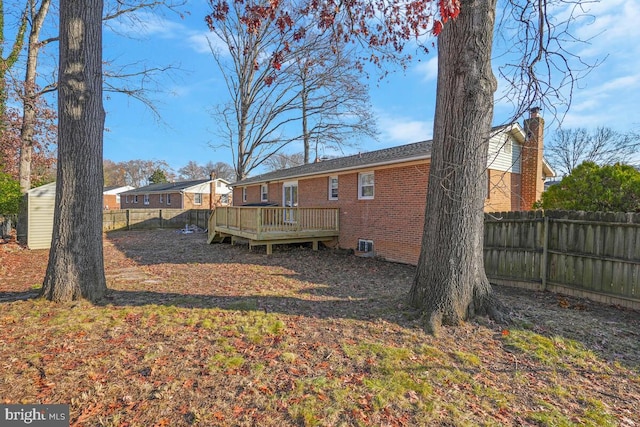 back of property featuring a wooden deck