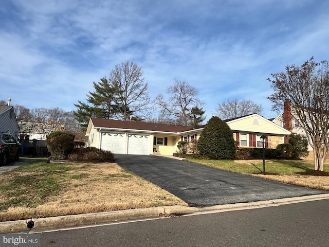 ranch-style house with a garage and a front lawn