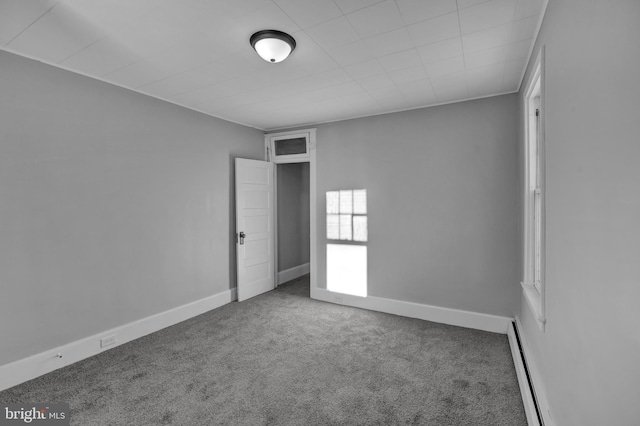 spare room with a baseboard radiator and carpet flooring