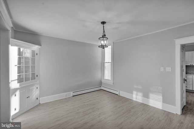 unfurnished dining area featuring ornamental molding, a notable chandelier, light hardwood / wood-style floors, and baseboard heating