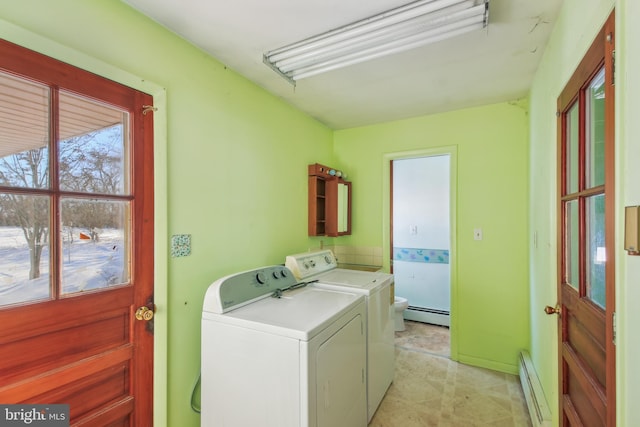 laundry area with separate washer and dryer and baseboard heating