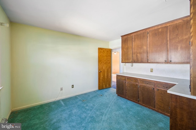 kitchen featuring light colored carpet