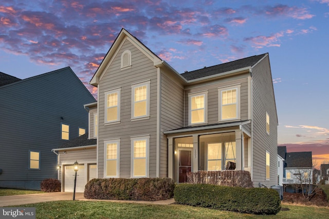 front of property featuring a garage and a yard