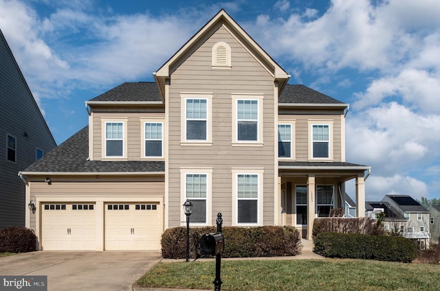 view of front of property featuring a garage, covered porch, and a front yard