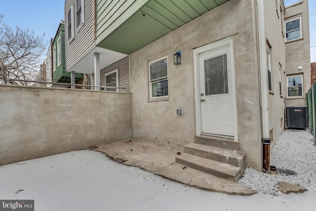 property entrance with cooling unit and a patio area