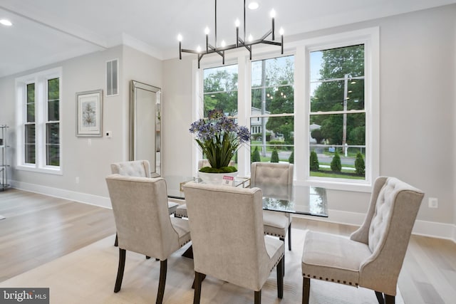 dining room with plenty of natural light, light hardwood / wood-style flooring, and a notable chandelier