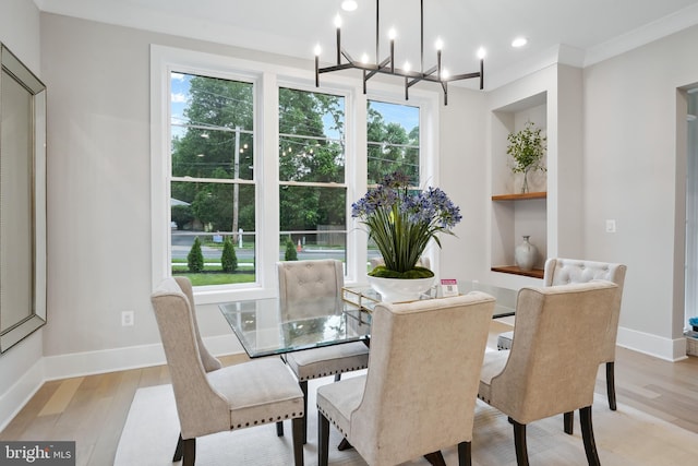 dining space featuring an inviting chandelier and light wood-type flooring