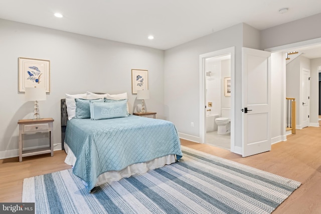 bedroom featuring light hardwood / wood-style floors and ensuite bathroom