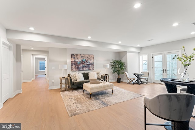 living room featuring french doors and light wood-type flooring