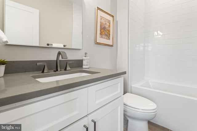 full bathroom featuring vanity, toilet, and  shower combination