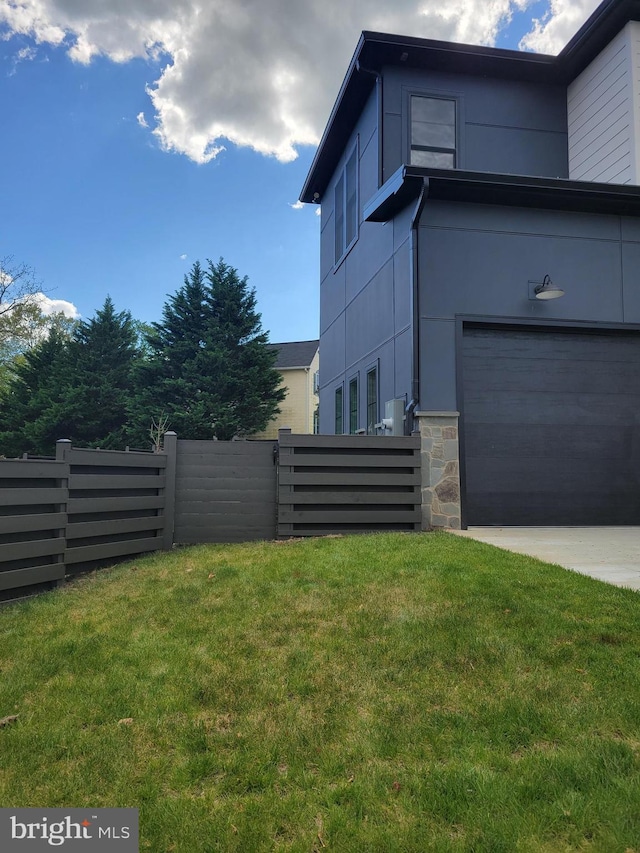 view of side of home with a yard and a garage