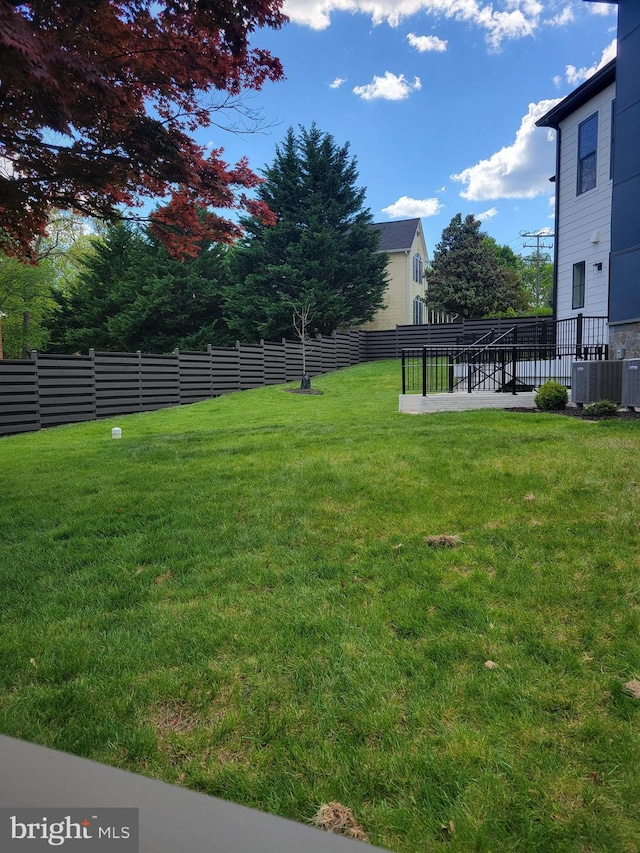 view of yard with central air condition unit