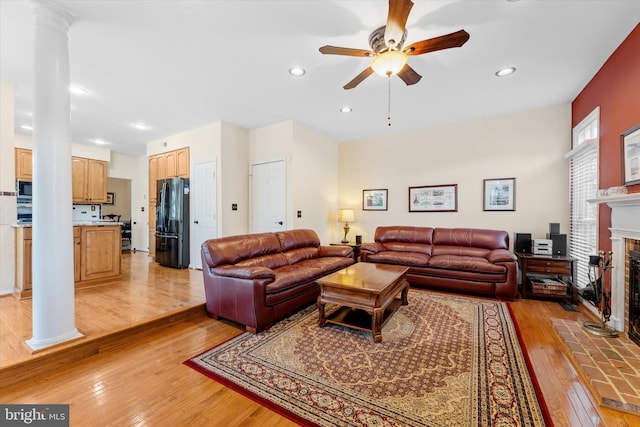 living room featuring ceiling fan and light hardwood / wood-style floors