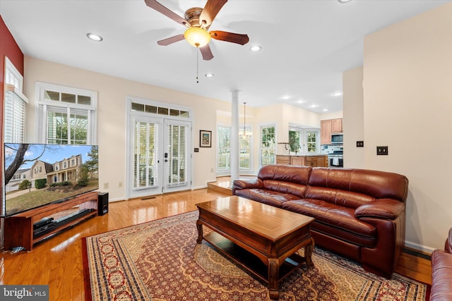 living room with french doors, ceiling fan, a healthy amount of sunlight, and light hardwood / wood-style floors