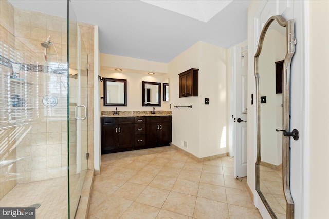 bathroom with an enclosed shower, vanity, and tile patterned floors