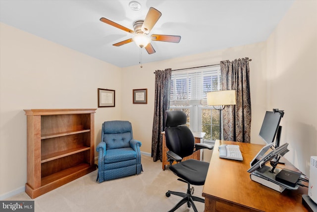 home office with light carpet and ceiling fan