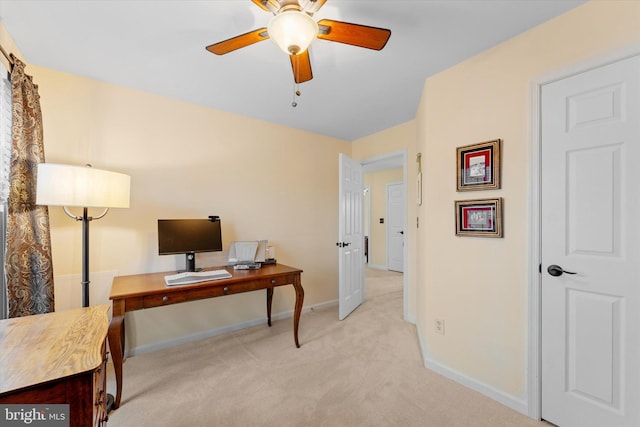 carpeted office space featuring ceiling fan