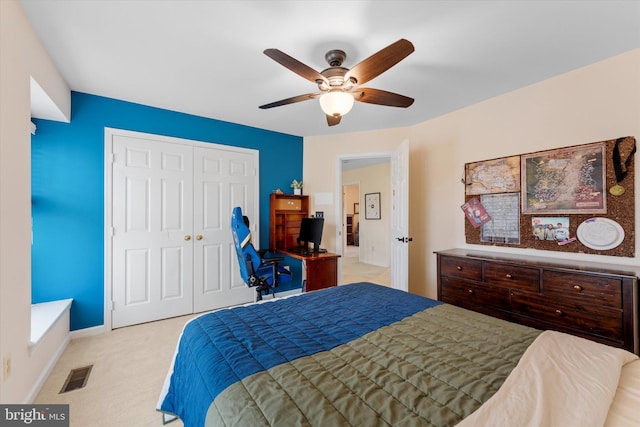 carpeted bedroom featuring ceiling fan and a closet