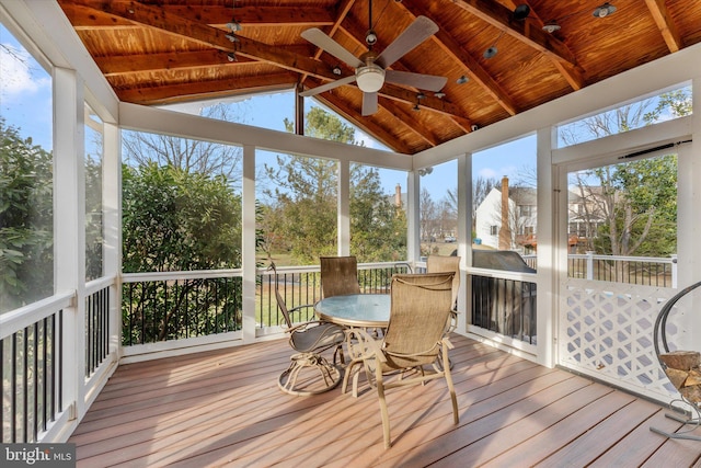 sunroom with vaulted ceiling, plenty of natural light, and wood ceiling