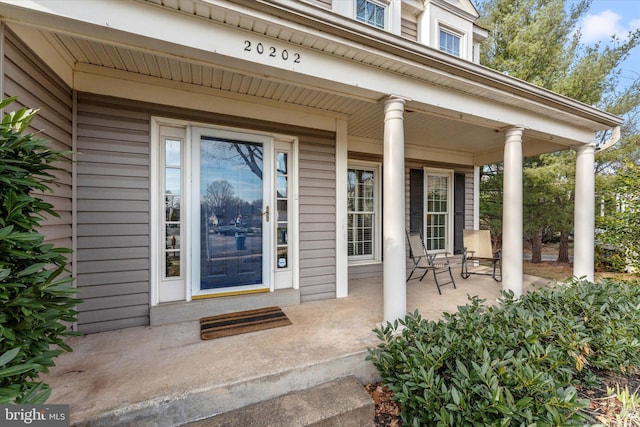 view of exterior entry with covered porch