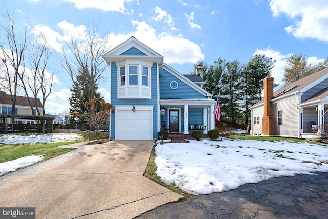 view of front facade with a garage and a porch