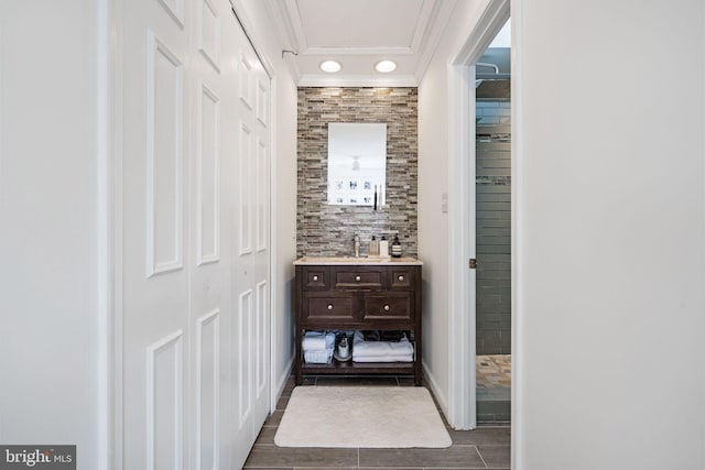 bathroom with crown molding and vanity